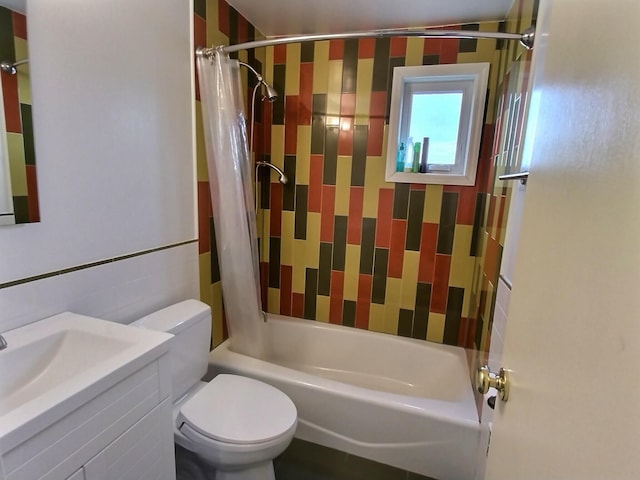 bathroom with shower / bath combo, vanity, and toilet