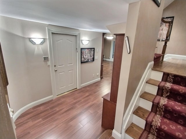 entryway featuring stairs, wood finished floors, and baseboards