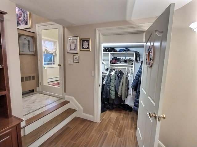 interior space featuring wood tiled floor, radiator, and baseboard heating