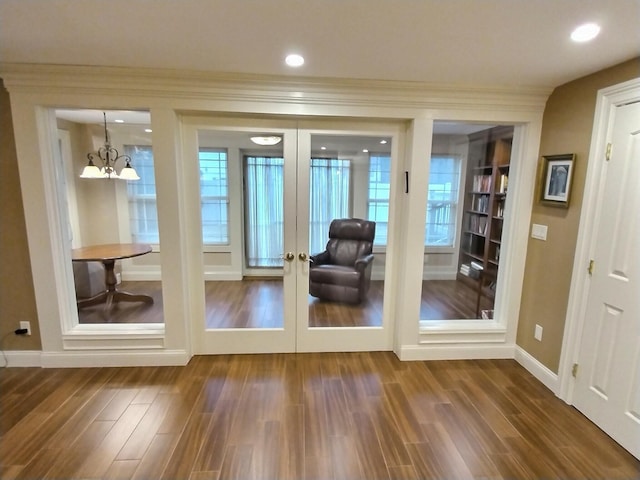 doorway with french doors, recessed lighting, dark wood-type flooring, ornamental molding, and baseboards