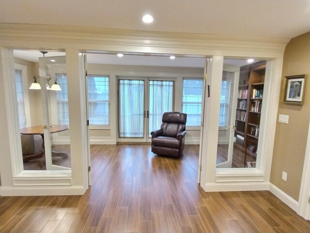 unfurnished room with crown molding, french doors, dark wood-type flooring, and baseboards