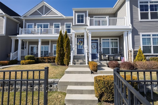 view of front of property featuring a porch and a balcony