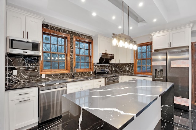 kitchen with a sink, appliances with stainless steel finishes, and white cabinets