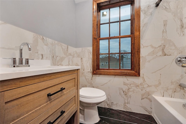 full bath with vanity, plenty of natural light, tile walls, toilet, and marble finish floor