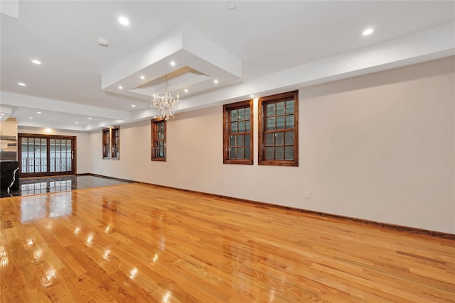 interior space featuring recessed lighting, light wood-style floors, and a tray ceiling