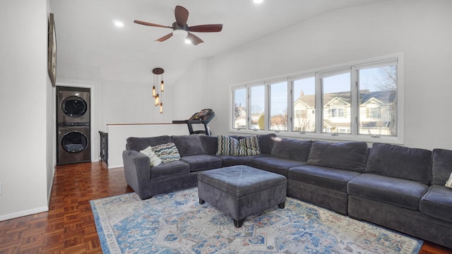 living area featuring baseboards, recessed lighting, ceiling fan, vaulted ceiling, and stacked washer and clothes dryer