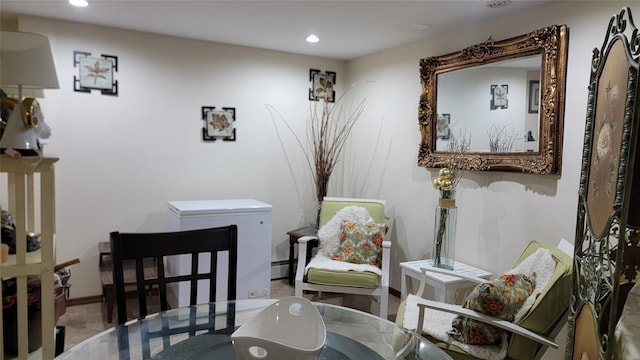 living area with recessed lighting, baseboards, and baseboard heating