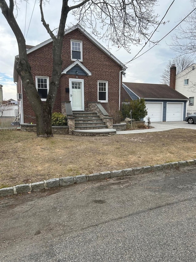 view of front facade featuring fence, driveway, entry steps, a garage, and brick siding