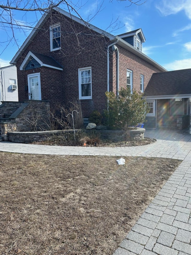 view of property exterior with brick siding