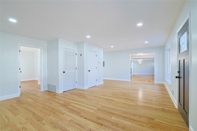 empty room with recessed lighting, baseboards, and light wood-style flooring