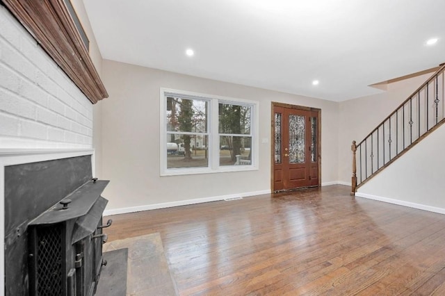 entrance foyer with stairs, recessed lighting, baseboards, and wood finished floors