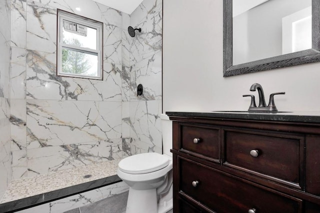 full bathroom with toilet, marble finish floor, a marble finish shower, and vanity