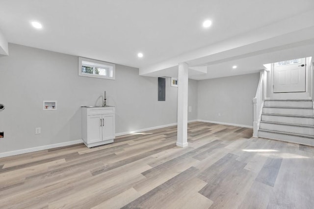 basement with light wood-type flooring, stairs, baseboards, and recessed lighting