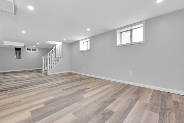 basement with recessed lighting, wood finished floors, and baseboards