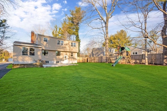 view of yard with a playground and fence