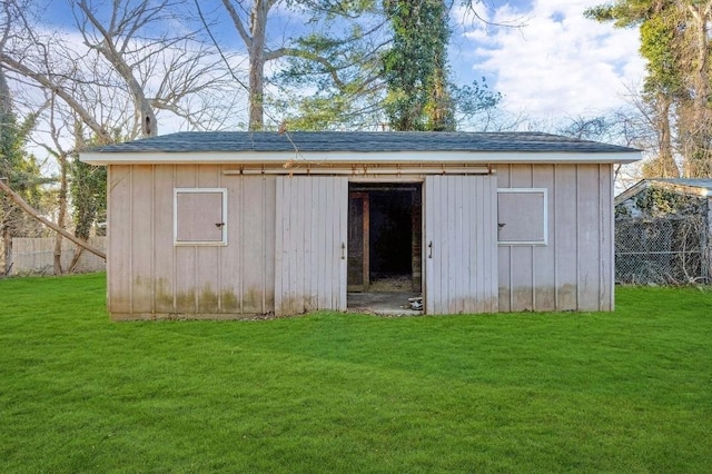 view of outdoor structure with an outbuilding and fence