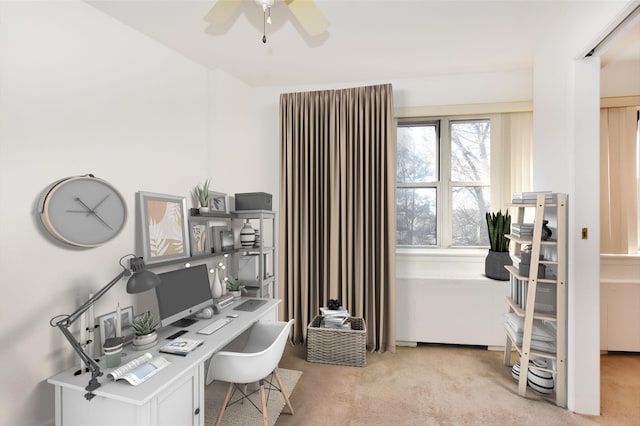 carpeted office featuring ceiling fan