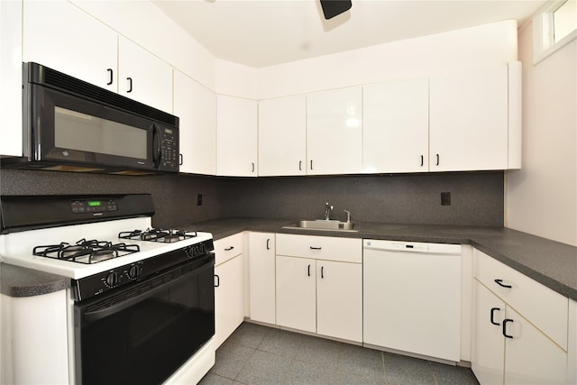 kitchen with dishwasher, dark countertops, gas range, black microwave, and a sink