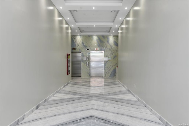 hall featuring recessed lighting, elevator, a raised ceiling, and baseboards