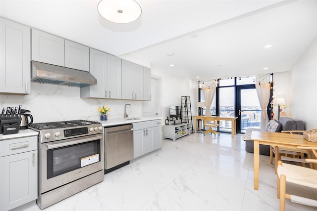 41-62 Bowne St Unit 12G, Flushing, NY 11355 - kitchen with a sink, stainless steel appliances, under cabinet range hood, marble finish floor, and light countertops