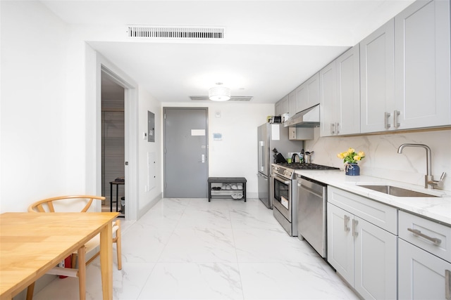 41-62 Bowne St Unit 12G, Flushing, NY 11355 - kitchen featuring a sink, under cabinet range hood, marble finish floor, visible vents, and appliances with stainless steel finishes