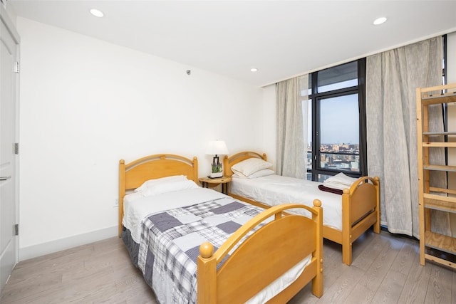 41-62 Bowne St Unit 12G, Flushing, NY 11355 - bedroom with recessed lighting, wood finished floors, and baseboards