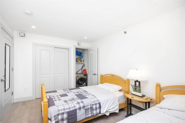 41-62 Bowne St Unit 12G, Flushing, NY 11355 - bedroom featuring baseboards, a closet, recessed lighting, wood finished floors, and washer / dryer