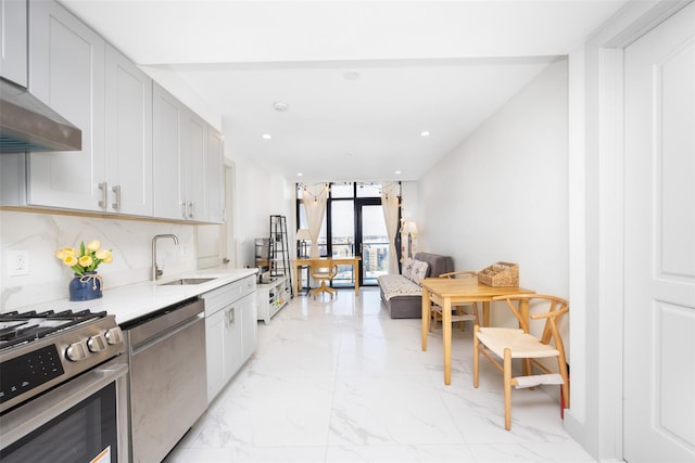 41-62 Bowne St Unit 12G, Flushing, NY 11355 - kitchen featuring a sink, stainless steel appliances, under cabinet range hood, recessed lighting, and marble finish floor