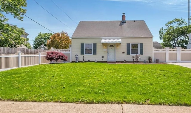 cape cod home with fence private yard, a chimney, and a front yard