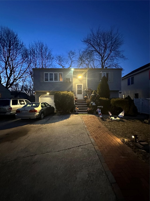 bi-level home featuring concrete driveway