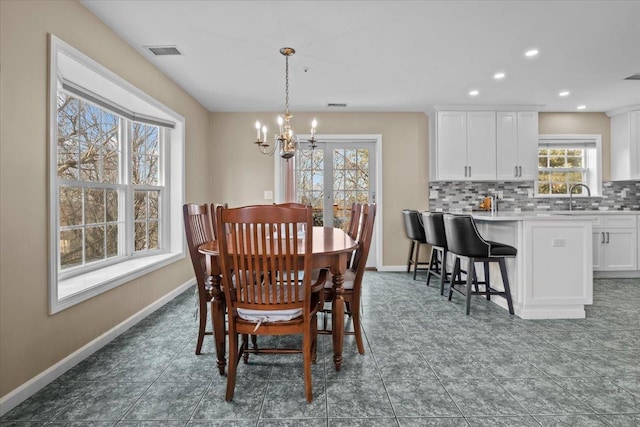 dining space featuring recessed lighting, visible vents, baseboards, and an inviting chandelier