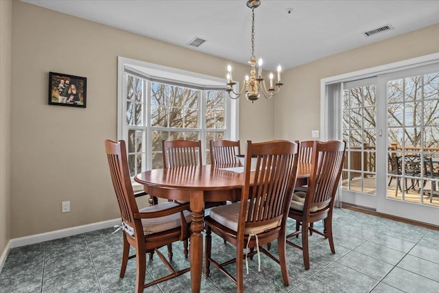 dining space with tile patterned floors, baseboards, visible vents, and a chandelier