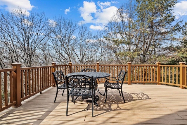 wooden deck featuring outdoor dining area