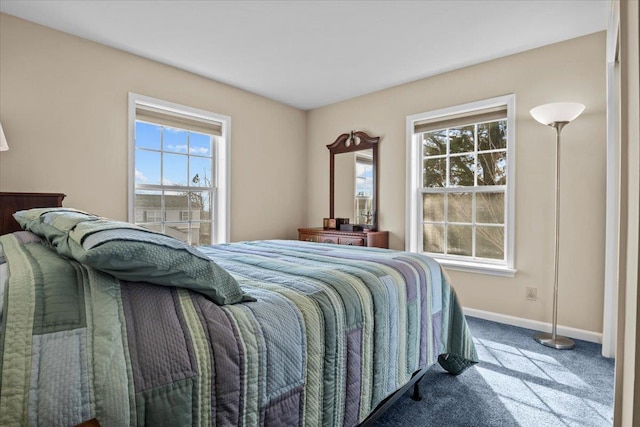 bedroom with baseboards and carpet