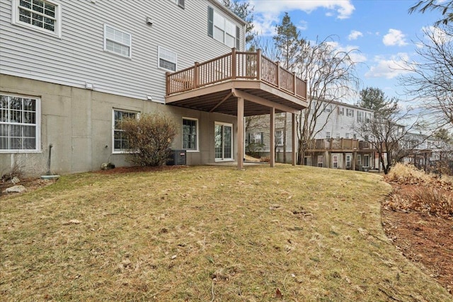 back of house with central air condition unit, a lawn, and a deck