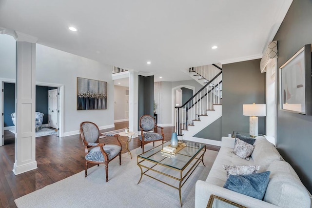 living area with stairway, recessed lighting, ornate columns, and wood finished floors