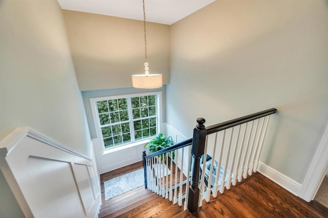 stairs with wood finished floors and baseboards