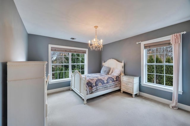 bedroom featuring light colored carpet, visible vents, and baseboards