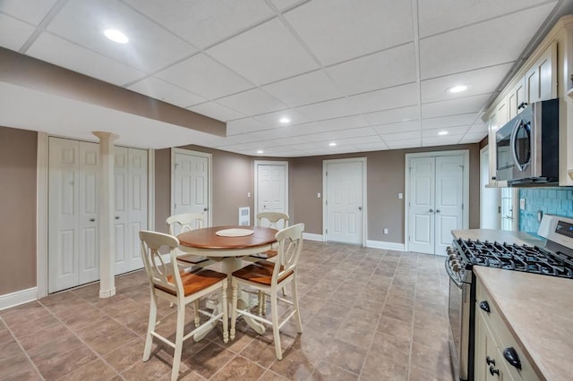 dining area featuring recessed lighting, baseboards, and a drop ceiling