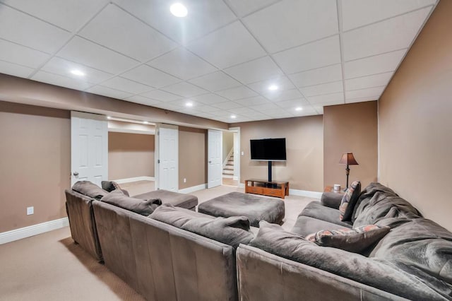 living area with recessed lighting, light colored carpet, baseboards, and a paneled ceiling