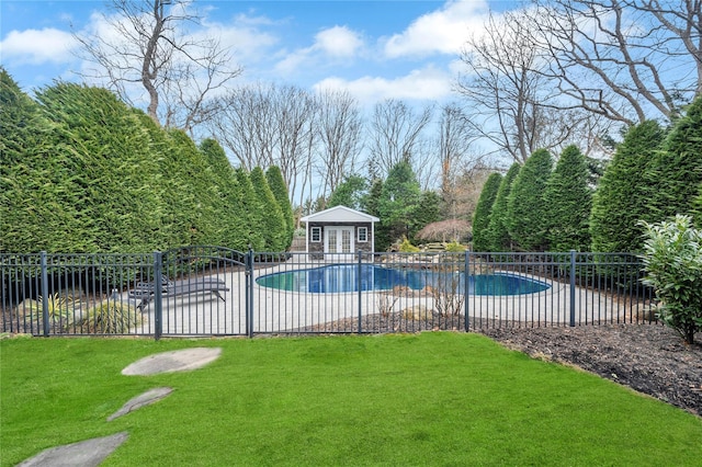 view of pool with an outbuilding, a storage structure, fence, and a patio area