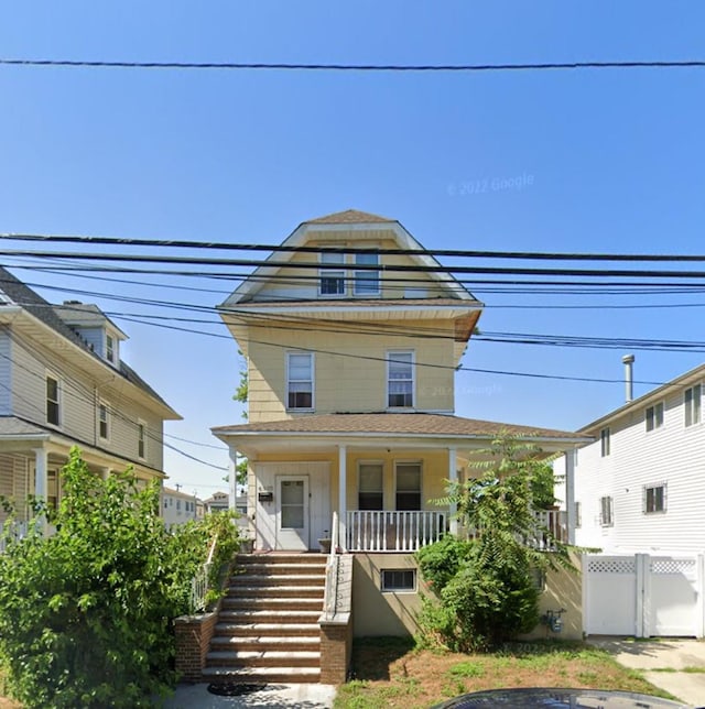 view of front of house featuring covered porch and stairway