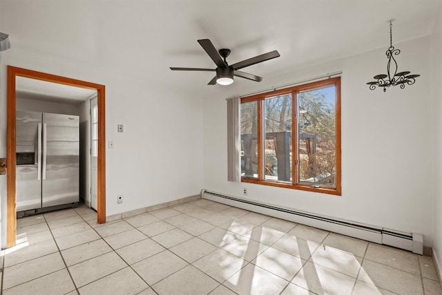 unfurnished room with baseboards, baseboard heating, light tile patterned flooring, and ceiling fan with notable chandelier