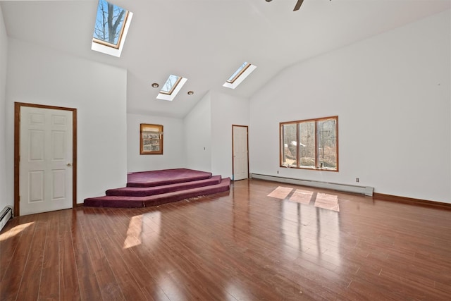 interior space with high vaulted ceiling, a baseboard heating unit, a ceiling fan, and wood finished floors