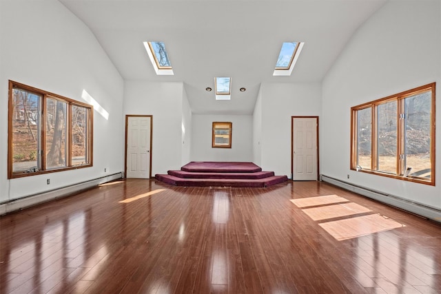 interior space with a baseboard radiator, wood-type flooring, and high vaulted ceiling