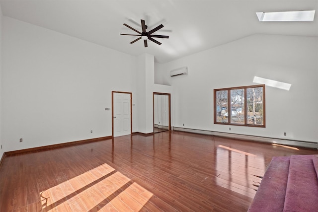 empty room featuring a wall unit AC, a skylight, wood finished floors, and baseboard heating