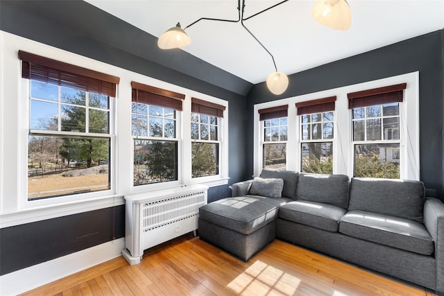 sunroom / solarium featuring lofted ceiling and radiator heating unit