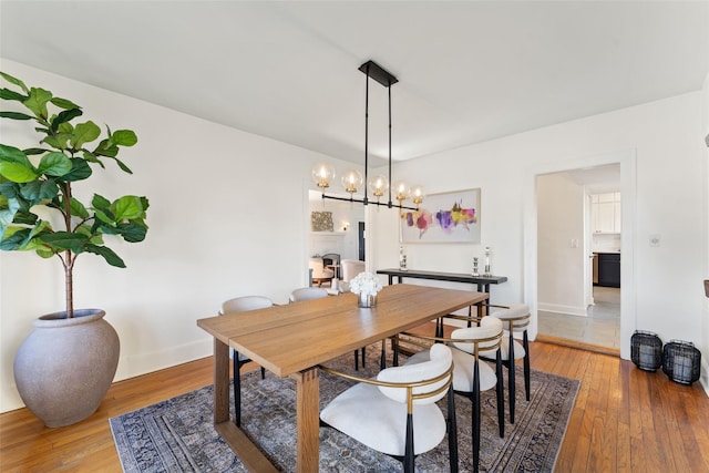 dining room with light wood-type flooring and baseboards