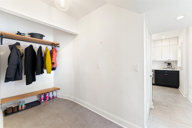 mudroom with vaulted ceiling, light tile patterned flooring, recessed lighting, and baseboards