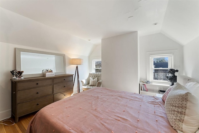 bedroom featuring vaulted ceiling and wood finished floors